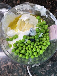 green peas, greek yogurt, olive oil and garlic in a food processor bowl