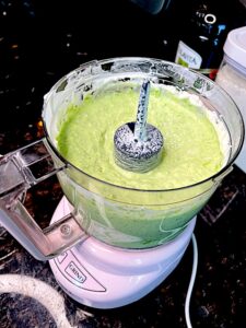 puree of green peas, greek yogurt, olive oil and garlic in a food processor bowl