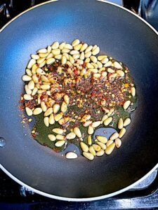 pine nuts, olive oil, red pepper flakes in a skillet