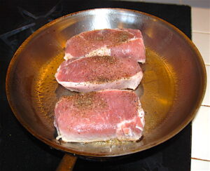 Pork Boneless Loin Chop searing in skillet